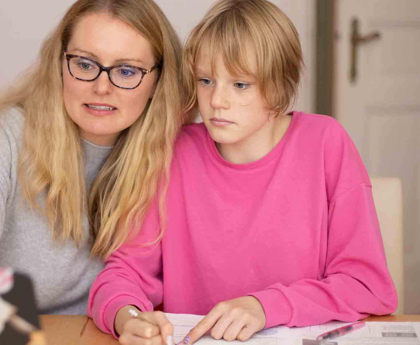 Full-time professional foster parent helping a teenage daughter with homework.