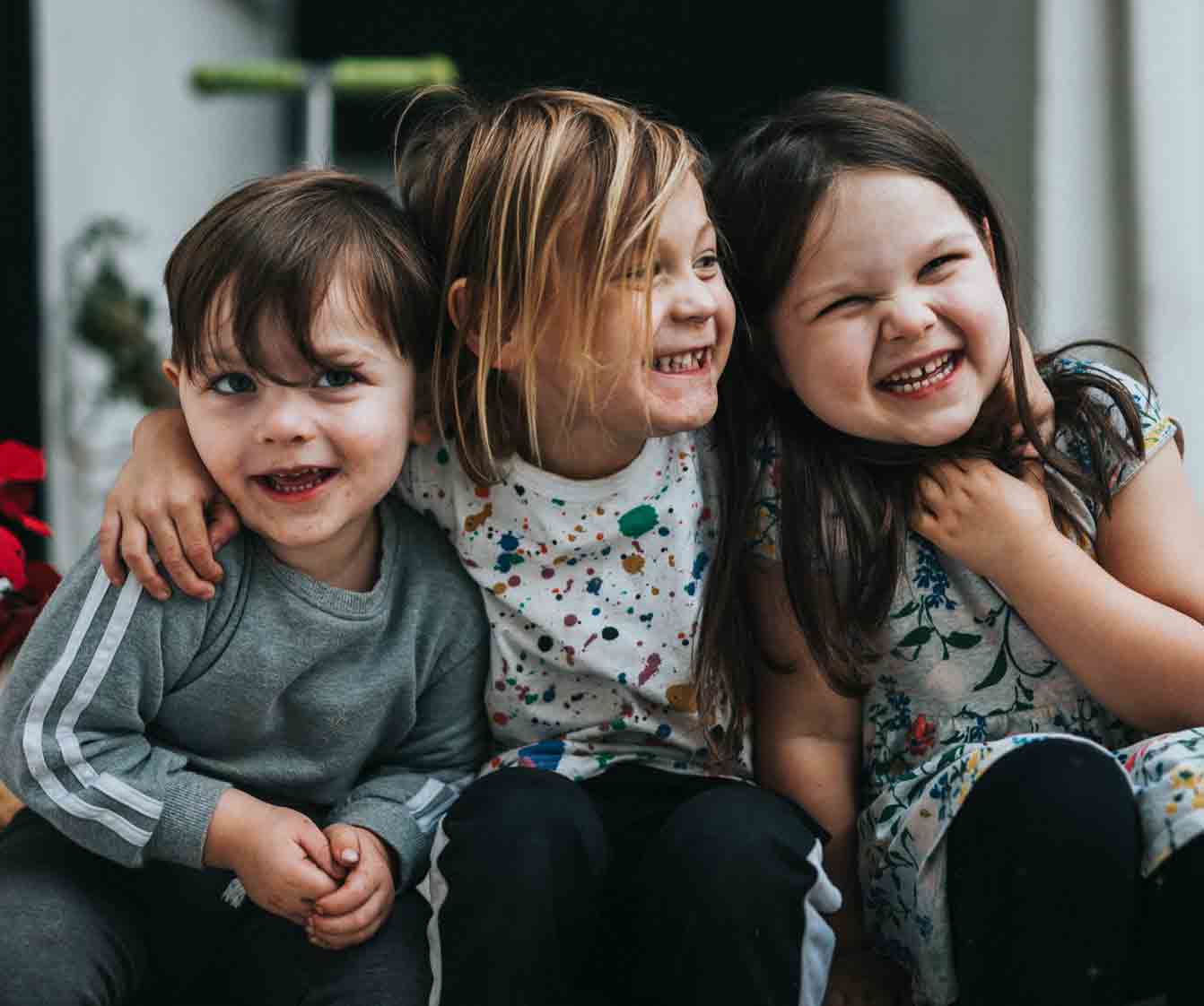 Three kids smiling.