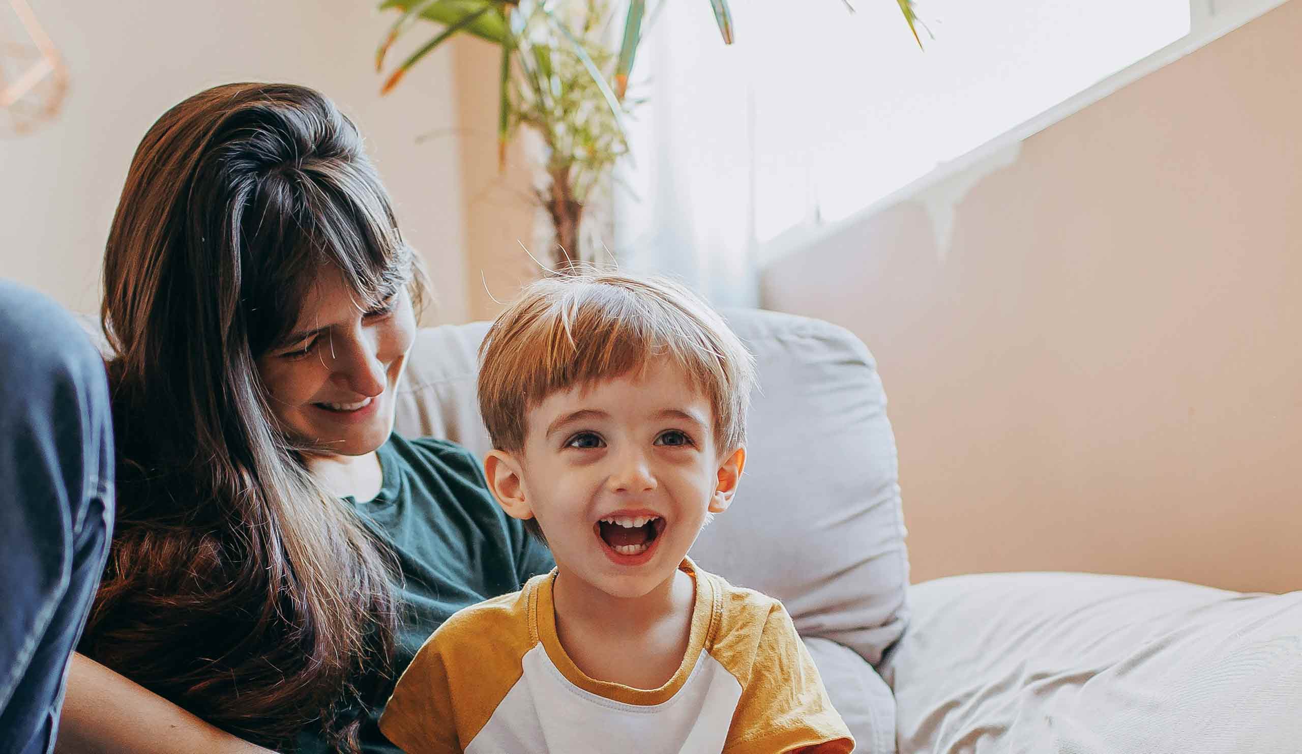 Smiling child and caregiver , Together California Foster Care supports a village for brothers and sisters to stay together.