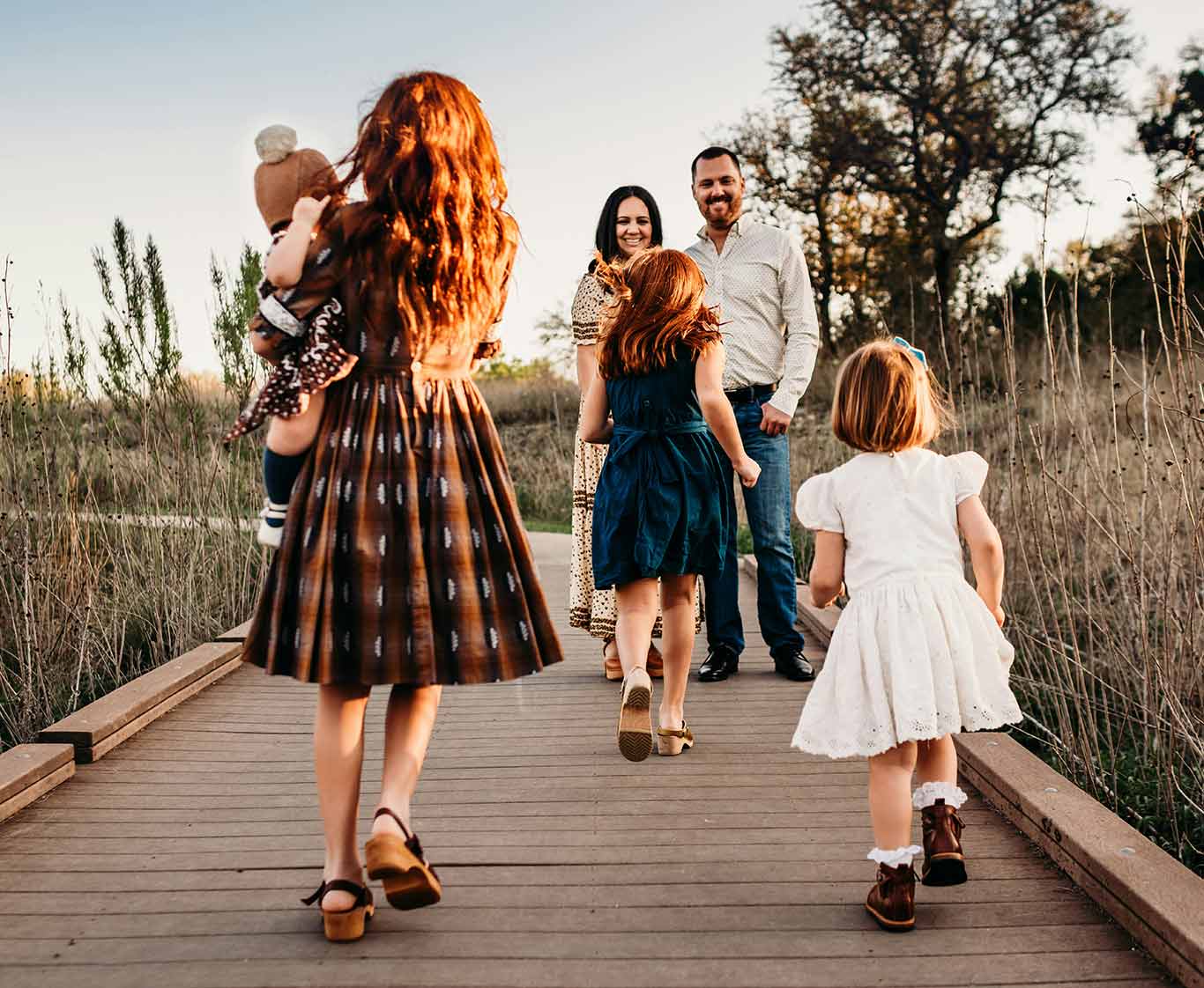 Family walking together outdoors, representing Together California Foster Care's village for brothers and sisters to stay united.