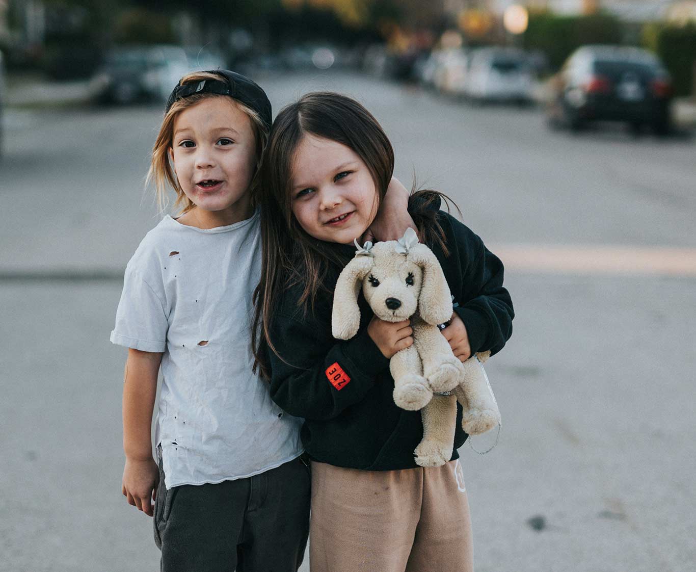 Siblings smiling looking at the camera.